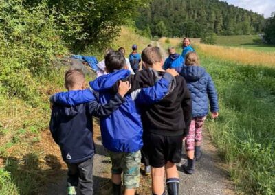 Schülerinnen und Schüler mit Lehrerin auf dem Weg zu einer Bachuntersuchung